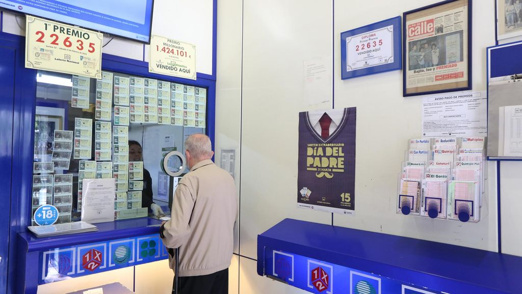 Archivo - Un hombre compra lotería en una Administración de Lotería